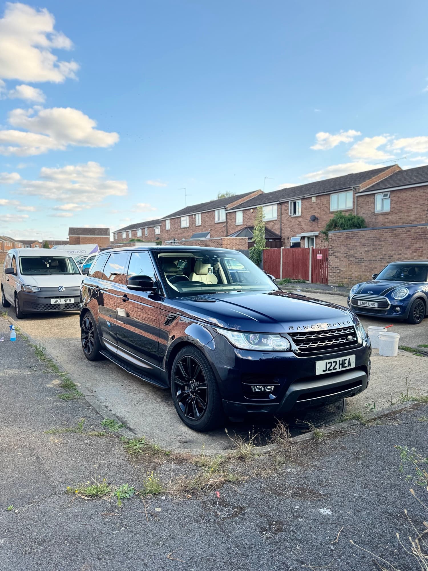 A Range Rover Sport being detailed at home, with the fully equipped SB Detailers van set up on the driveway